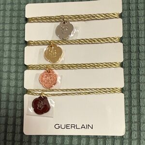 Guerlain Gold and Red Charm Bracelets